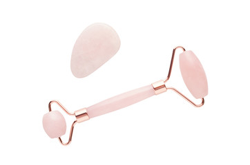 rose quartz facial roller and massage stone gua sha isolated on white background, flat lay