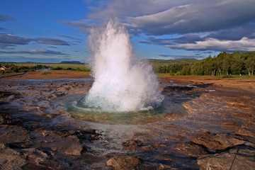 Geysir Strokkur outbreak with blue sky