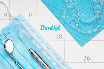 Orthodontist or Dentist appointment in calendar professional dental tools with invisalign braces.