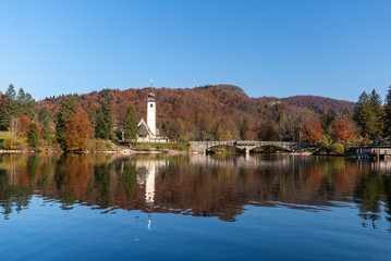Church of Sv. John the Baptist and a bridge by the Bohinj lake in winter, Slovenia