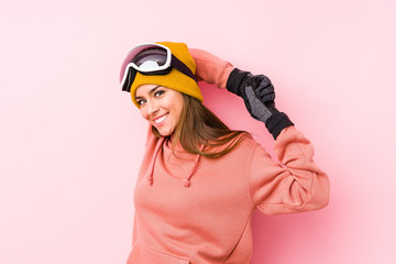 Young caucasian woman wearing a ski clothes isolated stretching arms, relaxed position.