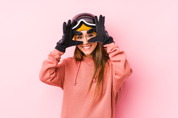 Young caucasian woman wearing a ski clothes isolated showing okay sign over eyes