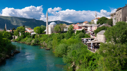 Fototapeta premium Mostar / Bosnia and Herzegovina April 2019: Koski Mehmed Pasha Mosque in the center of shore of Neretva river in Mostar city, historic and touristic place in Balkan peninsula, Southeastern Europe