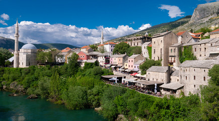 Panoramic view of old town in Mostar with Koski Mehmed Mosque and Neretva river, taken from iconic Old Bridge (Stari Most) in Mostar, Bosna and Herzegovina