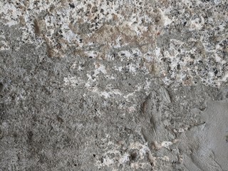 Rough pebbled and broken cement and concrete wall