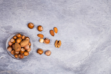 Assortment of nuts on a black slate or stone background