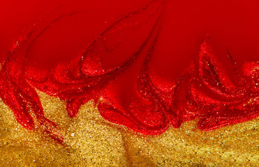 Red and gold nail polish liquid texture.
