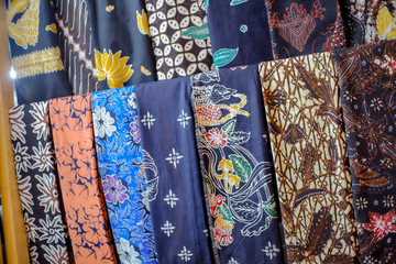 Beautiful and colorful batik fabric, hang on a shelf in a shopping mall. Javanese Batik. Indonesian Batik