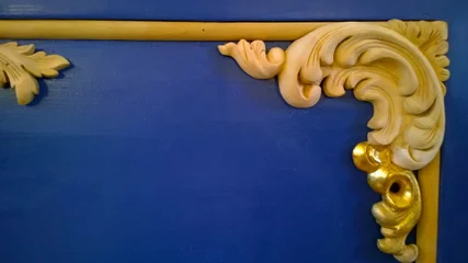 Fotobehang Oude meesters The corner of the antique vintage wooden frame on the wall background in classic blue color with azure. Partially gilded ornament after restoration. Decor Elements. Design and decor. Copy space.  © NVS my world