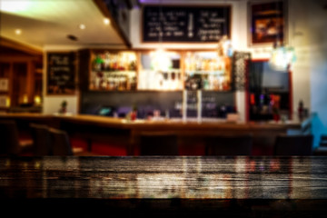 Table background of free space for your decoration and blurred background of bar 