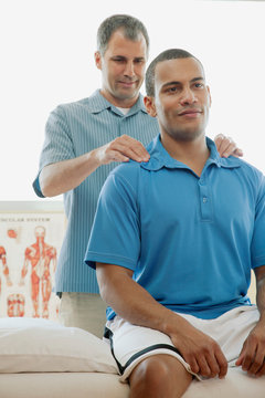 Male Patient Receiving A Chiropractic Adjustment