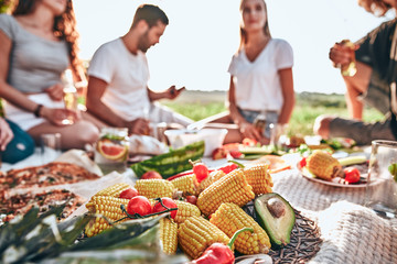 Close up view corn, tomato and avocado on the plate at a picnic