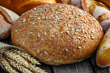 loaf of bread on wooden background, food closeup.Fresh homemade bread.French bread. Bread at leaven. Unleavened bread.Ciabatta bread.