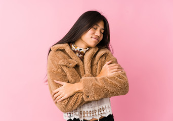 Young asian woman hugs, smiling carefree and happy.