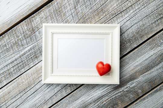 Love Valentine's Day concept. Blank picture frame and heart.
