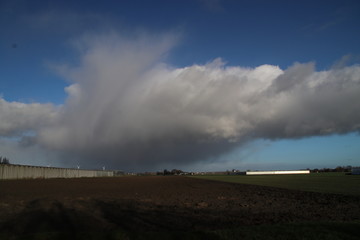 Fototapeta na wymiar stratocumulus clouds with rain showers above the Zuidplaspolder in Zevenhuizen the Netherlands