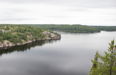 Fototapeta na wymiar Landscape views over the forested lake