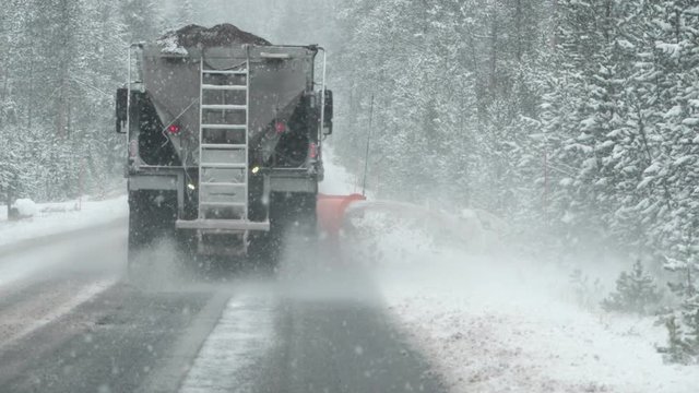 slow motion clip of a snow plow clearing part of the grand loop road in yellowstone national park of wyoming, usa