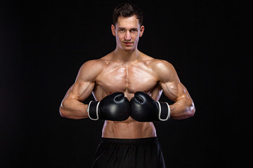 Fitness and boxing concept. Boxer, man fighting or posing in gloves on black background. Individual...