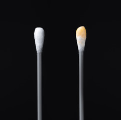 Before and after using the ear stick. Cotton sticks isolated on black background
