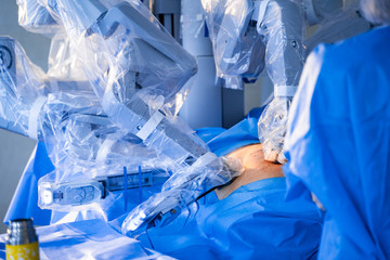 Medical robot. Medical operation involving robot. Robotic Surgery. Manipulators performing surgery on a patient.