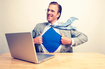 Superhero businessman giving a cheeky wink to the camera as he gets ready to save the day from his...