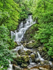 Beautiful, green Torc Waterfall in Killarney National Park in Kerry, Ireland | long time exposure photo, green environment