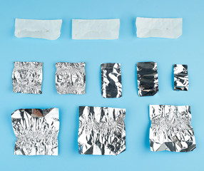 various crumpled white paper and foil used candy wrappers
