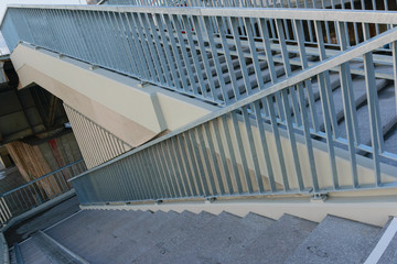 Fototapeta premium concrete staircase with metal railing descent from the bridge. down stair.