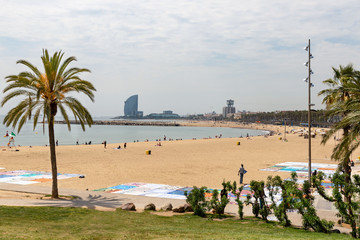 City beach in Barcelona, people relax on the sand. Spain, Barcelona may 2019