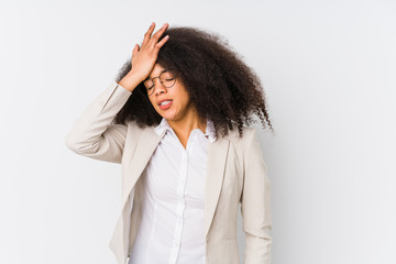 Young african american business woman forgetting something, slapping forehead with palm and closing...