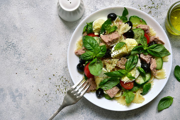 Pasta salad with preserved tuna, vegetables and eggs. Top view with copy space.