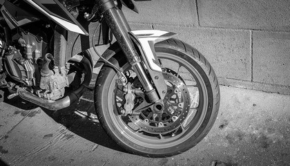 Big motorbike wheel closeup orange and chrome.Black and white style.