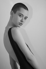 black and white photo of young woman  in black bodysuit torso art posing beautiful short hair woman fashion model  