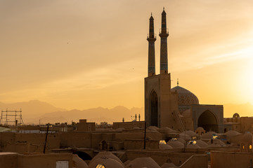 Views of the skyline with minarets and domes of Yazd at sunset, Iran