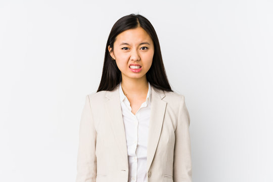 Young chinese business woman isolated screaming very angry and aggressive.