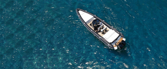 Aerial drone ultra wide photo of inflatable rigid power boat docked in Mediterranean deep blue sea...
