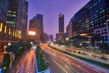 Plakat Light trails on the busy traffic surrounded by Jakarta business office buildings in the dusk