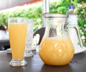 Orange juice carafe on the table.