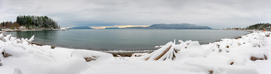 Panoramic View of Rosario Strait After a Winter Snowstorm.  Seen from Lummi Island in the Pacific Northwest, Orcas Island in the background, receives a dusting of snow in the Salish Sea. 
