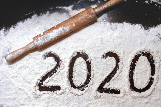 numbers 2020 paint on flour table and rolling pin diagonal up