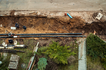 Repair of heating systems.Dug deep trench utilities engineering urban systems. Alarm urban sewerage...