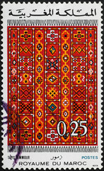 Colorful carpet on moroccan postage stamp