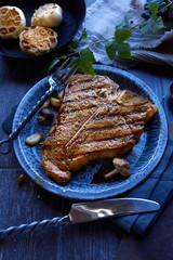 Grilled Tbone steak with garlic and mushrooms
