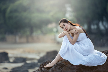 Sad and depressed woman deep in thought outdoors alone.