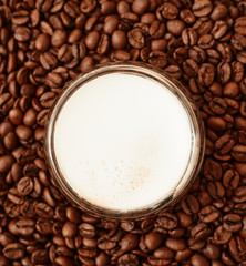 A cup of coffee in coffee beans. Coffee background
