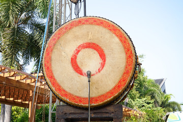 A big Taiko drum o-daiko on isolated red background. Musical percussion instrument of Asia