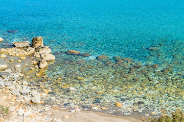 Beautiful idyllic turquoise waters coast with pebbles.