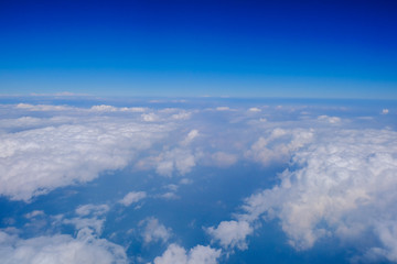 Fototapeta na wymiar Fluffy white cloud with blue sky above view from airplane