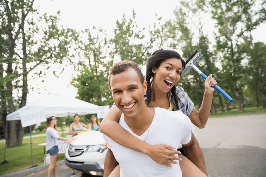 Portrait of smiling friends at car wash